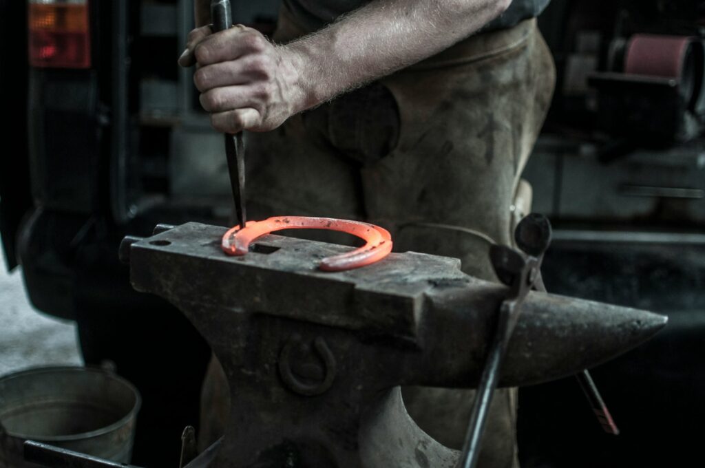 man forging horseshoe